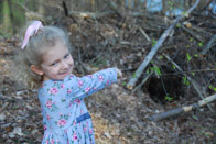 Audrey points out a bear's den below the barn, March 2007